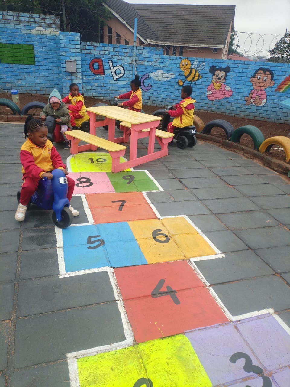 Children playing in the colourful Rainbow Kiddies playground